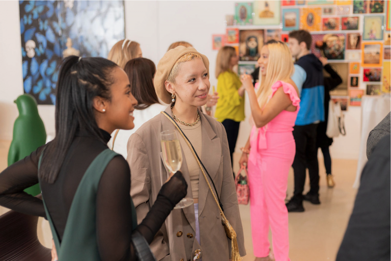 Friends talking in gallery